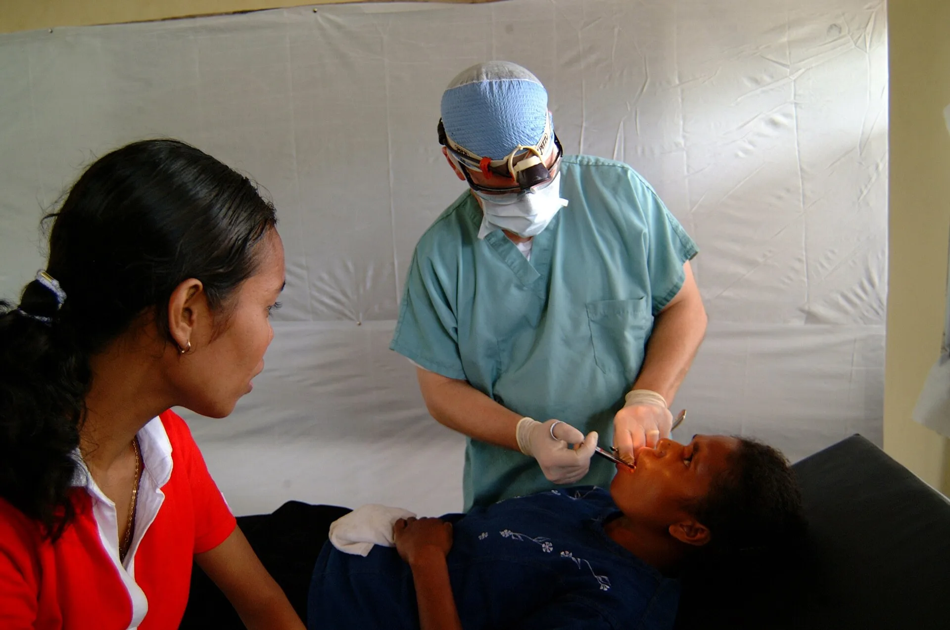 Alor, Indonesia (Mar. 26, 2005) - Cmdr. Mark Roback, a Navy dentist from the Military Sealift Command (MSC) hospital ship USNS Mercy (T-AH 19), speaking to his patient through an interpreter, tells her that the injection he is giving her will numb the area around her decaying tooth before he extract. Reading the dental content marketing examples closely