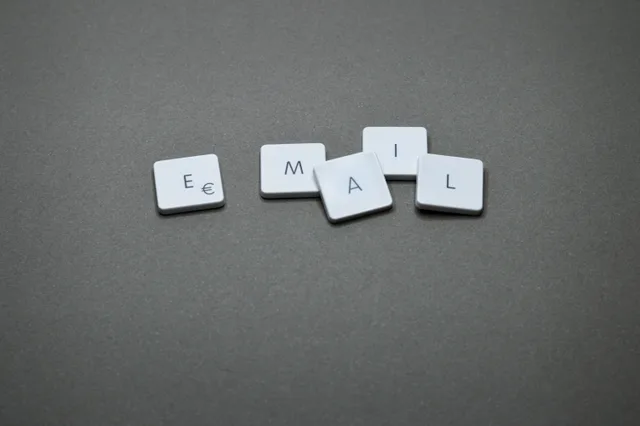 Close-up of the word 'email' formed with letter tiles on a gray surface. Dental email marketing trends: the shifts that matter