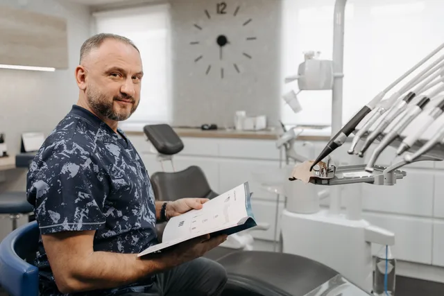 A dentist reviews patient records in a modern dental clinic setting. Dental marketing analytics: eight measurement practices and the US rules that apply