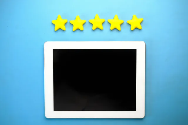 Tablet with five yellow stars on a blue background, ideal for rating concepts. Dental reputation management tools for people who want the details in 2027
