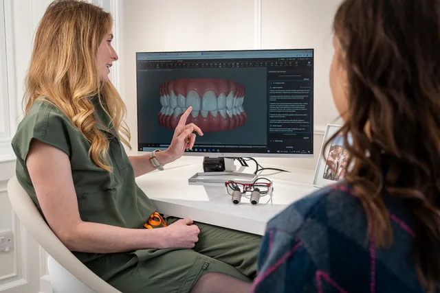 A dentist explains a 3D dental model to a patient during a consultation in Edinburgh. 4 things about dental SEO tools worth your time