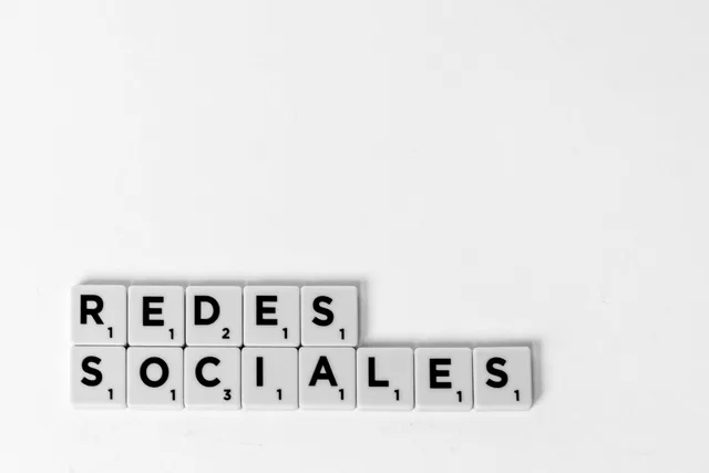 Scrabble tiles spelling 'Redes Sociales' illustrating a social media concept on a white background. What actually improves dental social media beyond posting more often?