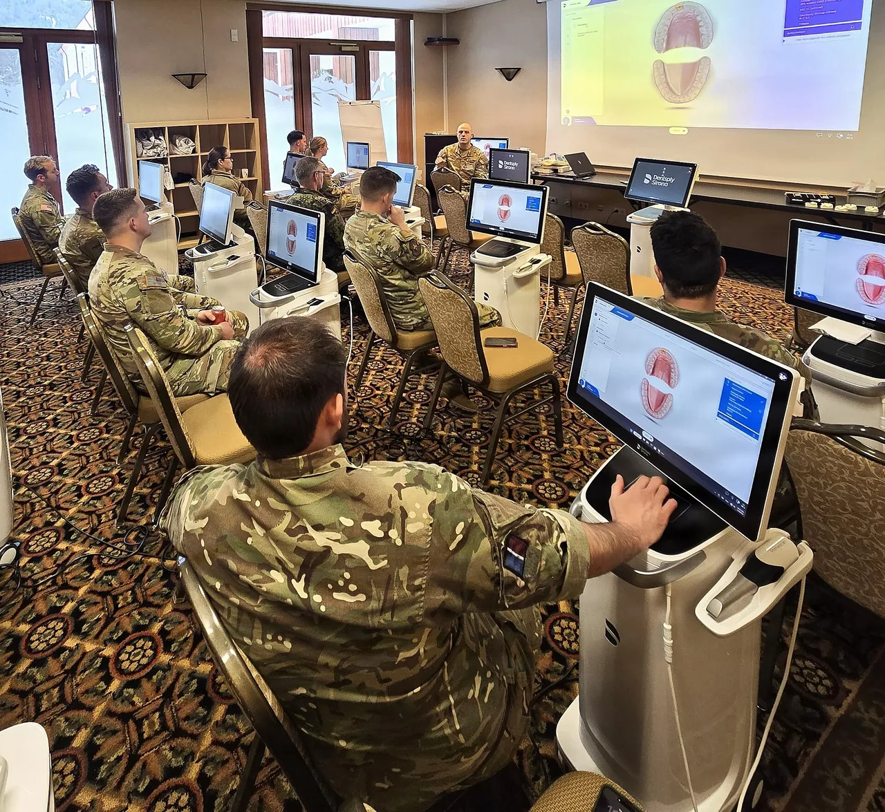 Dental officers attend a computer-aided dentistry training session.